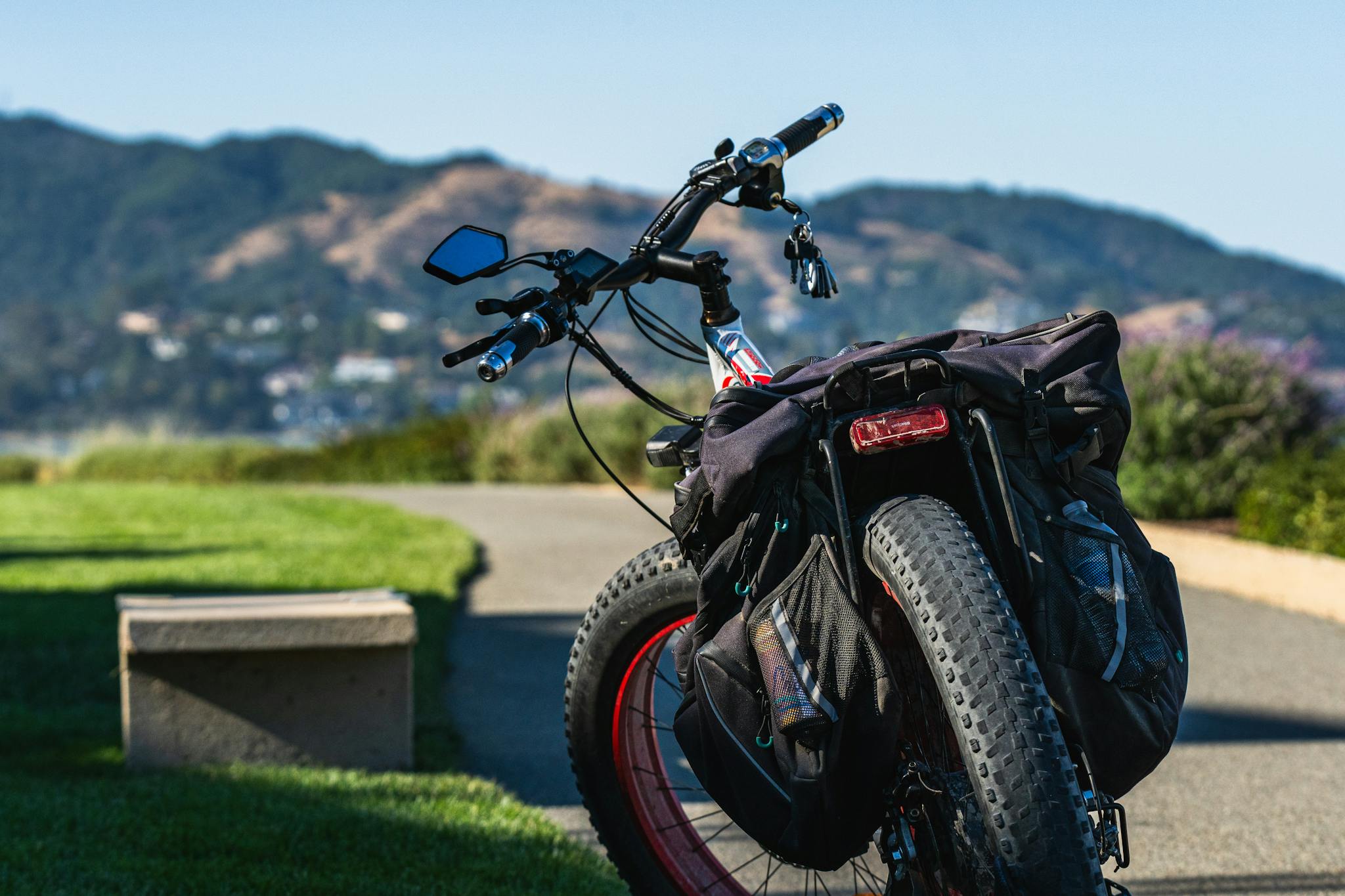 Electric bike parked on pathway with scenic mountain view for adventure travel.