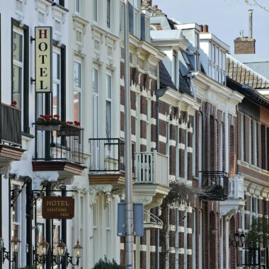 Historic street in Utrecht showcasing classic Dutch architecture and vibrant urban life.