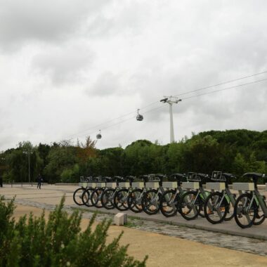 Scenic view of a bike station and cable cars on a cloudy day in Lisbon, Portugal.